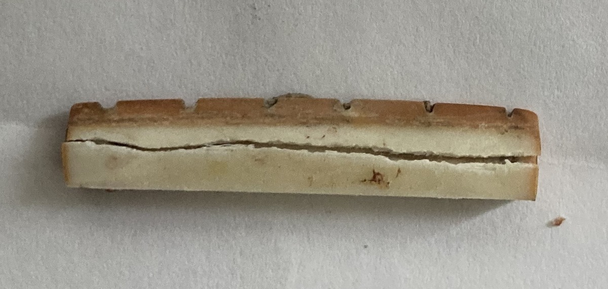 外した元のナット。上半分だけが茶色い